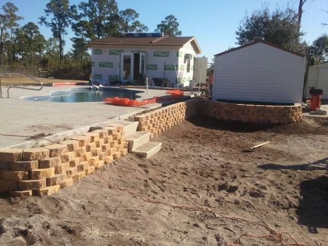 Poolside retaining wall and shed landscape project
